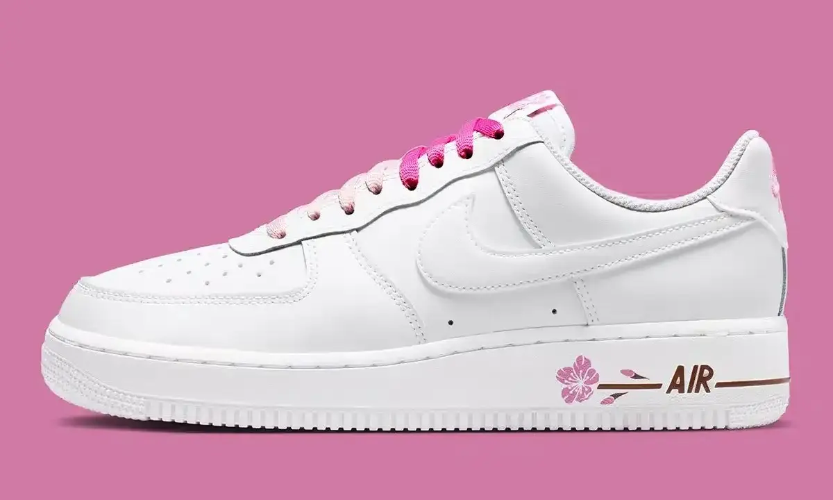 Nike Air Force 1 mit Sakura-Blüten-Detail und pinken Schnürsenkeln.