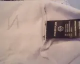 Etikett mit "Philipp Plein" und dem PP-Logo. Ein undeutliches "N" ist auf dem Stoff zu sehen. So erkennt man ein Philipp Plein Fake.