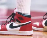 Die ersten Jordan Schuhe, rot-weiß-schwarz, auf einem Basketballfeld. Ein ikonischer Sneaker-Moment.