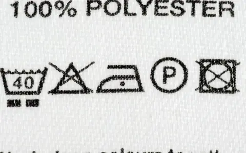Pflegehinweise für 100% Polyester: Maschinenwäsche bei 40°C, nicht bleichen, bügeln bei niedriger Temperatur, chemische Reinigung mit P, nicht im Trockner trocknen.